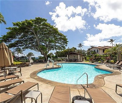 Pool and pool chairs at Lawai Beach Resort